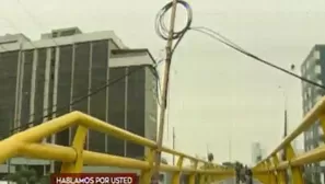 Poste de palo sostiene cables en puente peatonal. Foto: captura de TV