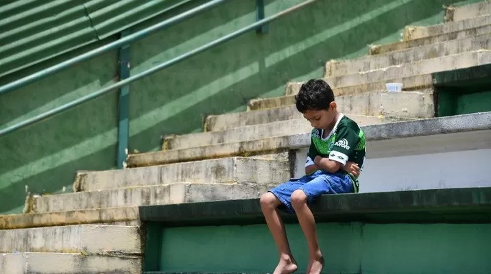 Un niño se sienta solo durante un tributo a los jugadores del equipo brasilero Chapecoense. (Vía: AFP) Un niño se sienta solo durante un tributo a los jugadores del equipo brasilero Chapecoense. (Vía: AFP)
