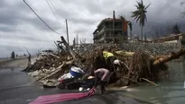 Una mujer lava su ropa en las calles de Port-Saul. (Vía: AFP)